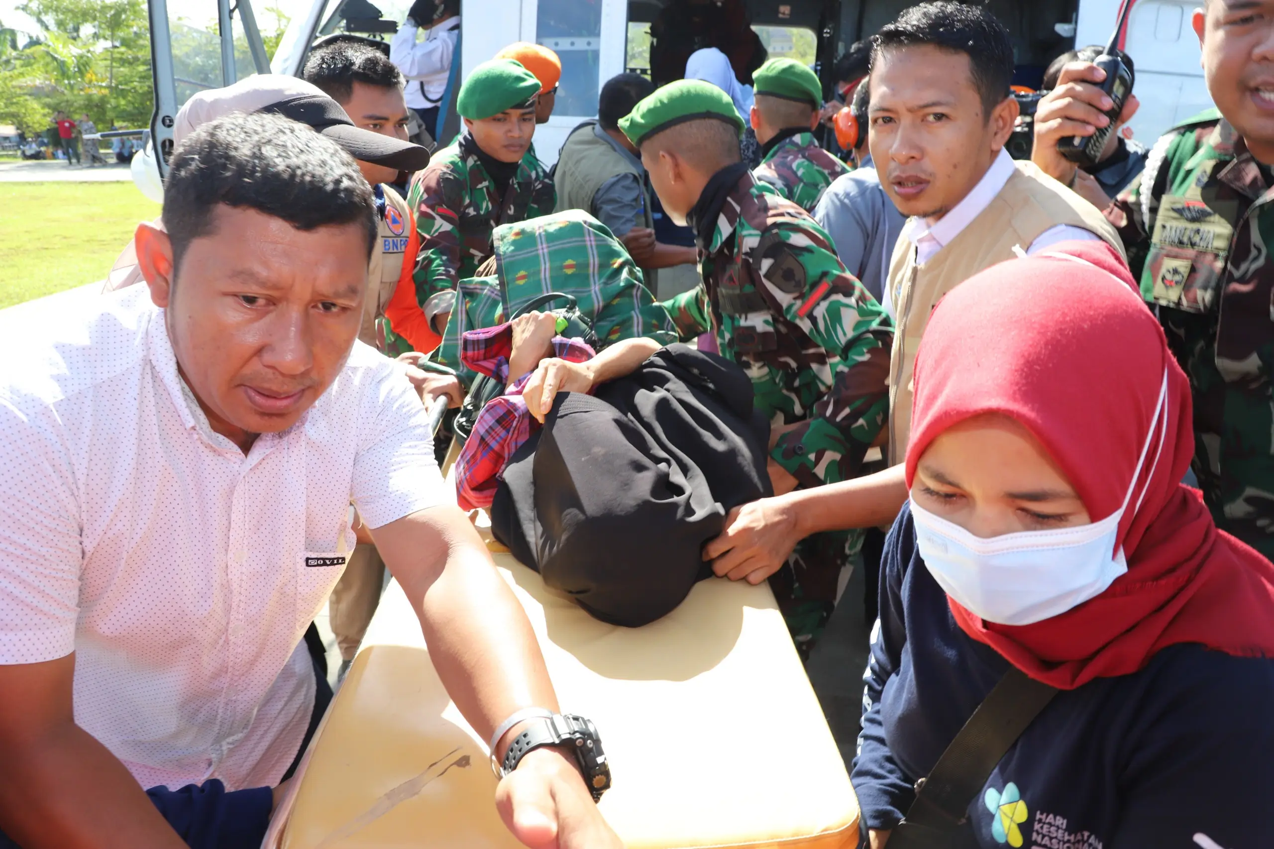Tim gabungan menurunkan warga yang sakit dari Helikopter Bell BNPB menuju Pos Kesehatan di Pos Komando Utama Tanggap Darurat Banjir dan Tanah Longsor Kabupaten Luwu Sulawesi Selatan, Rabu (8/5).